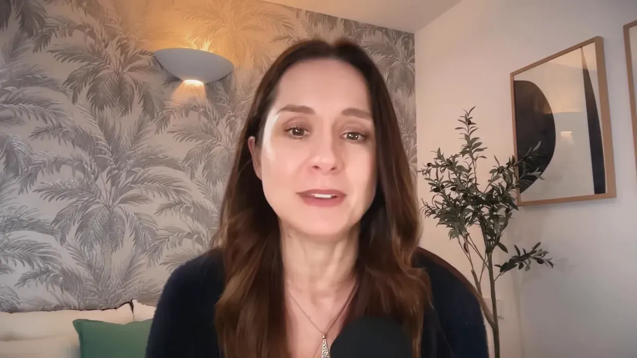 Portrait of the interviewee in a home office setting, looking at the camera while concluding the interview.